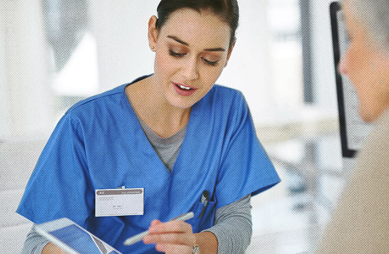 Nurse showing tablet computer screen to patient
